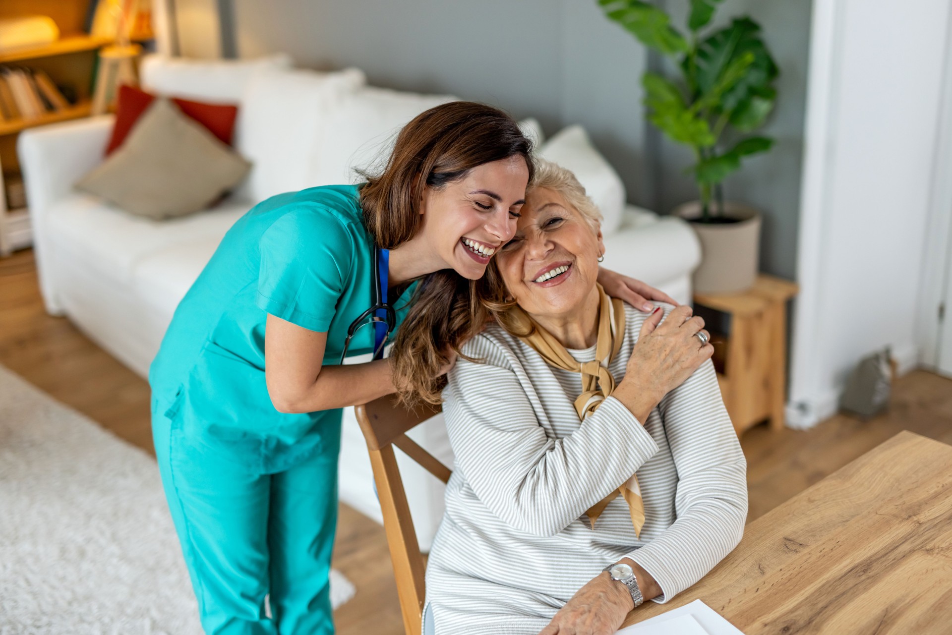 Healthcare Professional Embraces Elderly Woman in a Warm and Caring Setting